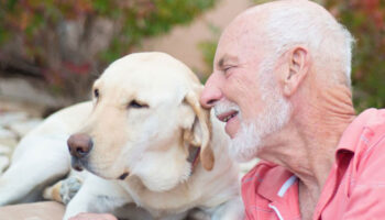 Senior man sitting with his dog.